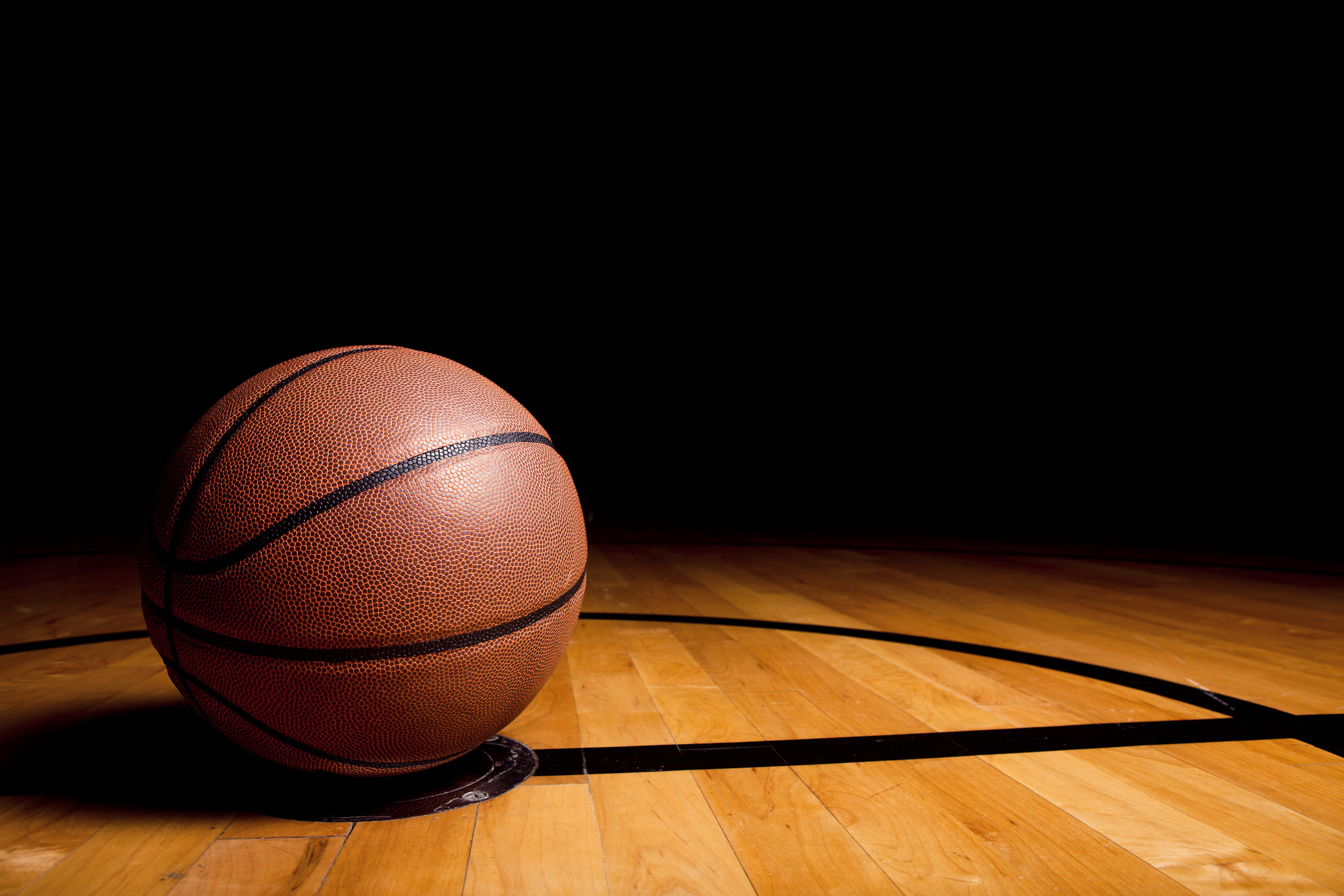 Lone basketball on the basketball court